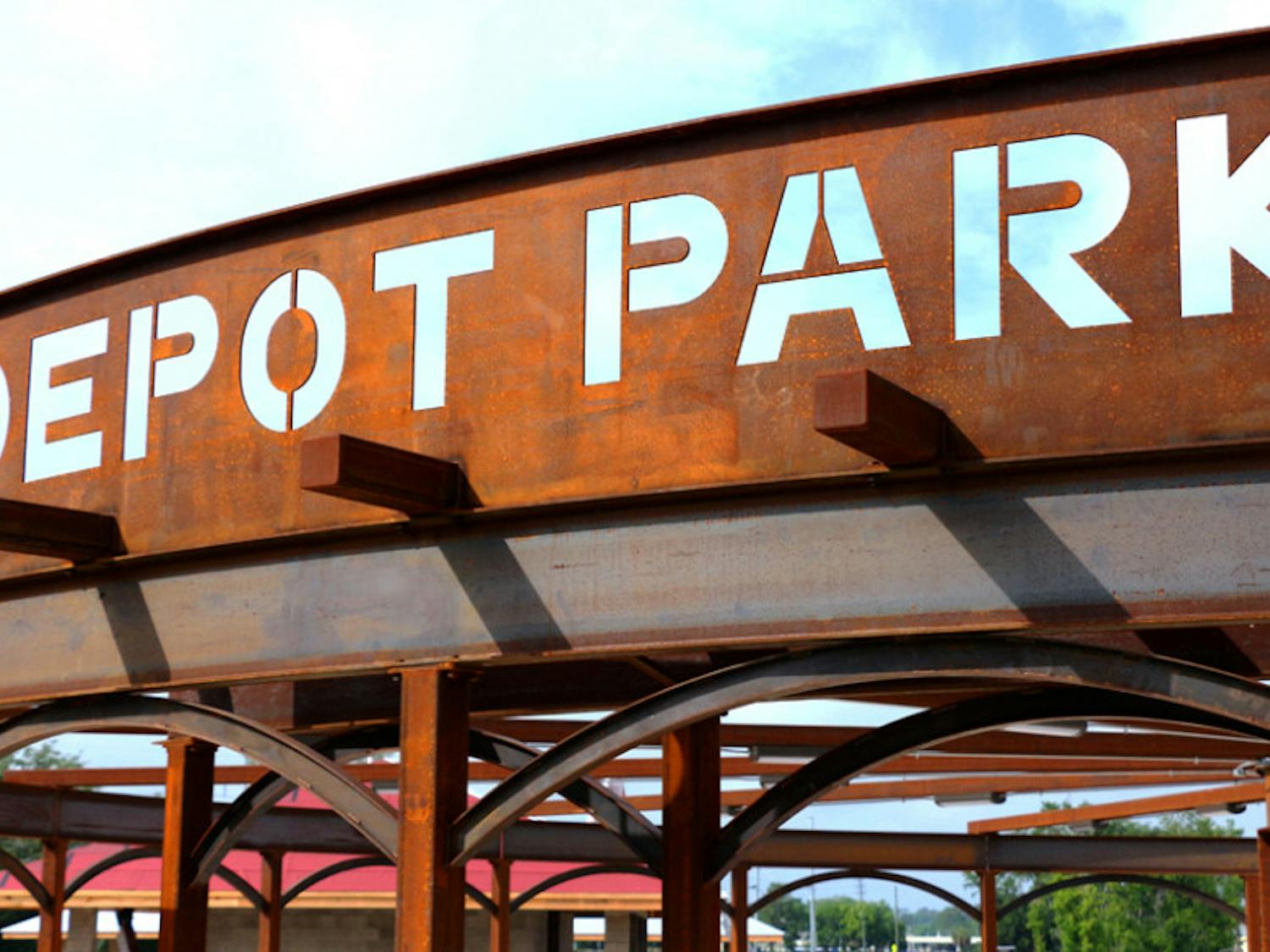 A rusted metal sign marking the entrance to Depot Park, which is being constructed in dedication to Gainesville’s industrial sector, evokes the history behind the land in downtown that used to be used as a railroad station.