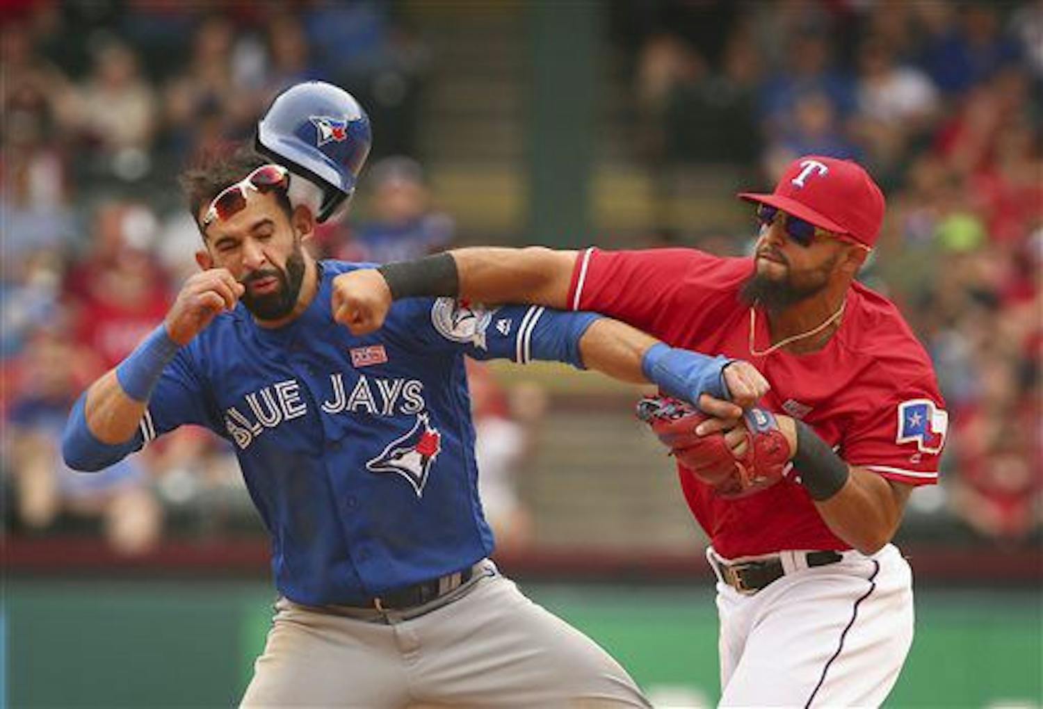 Toronto Blue Jays Jose Bautista (19) gets hit by Texas Rangers second baseman Rougned Odor (12) after Bautista slid into second in the eighth inning of a baseball game at Globe Life Park in Arlington, Texas, Sunday May 15, 2016. (Richard W. Rodriguez/Star-Telegram via AP)