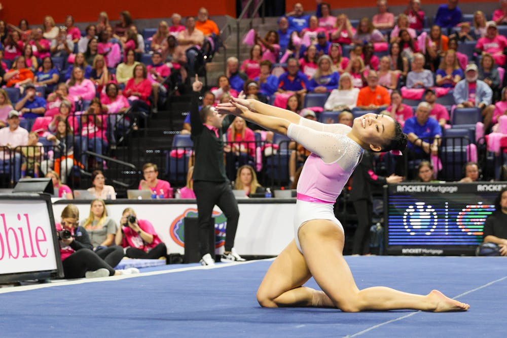 Leanne Wong finishes her floor routine with a gator chomp in a victory against the Missouri Tigers, Friday, Feb. 10, 2023. 