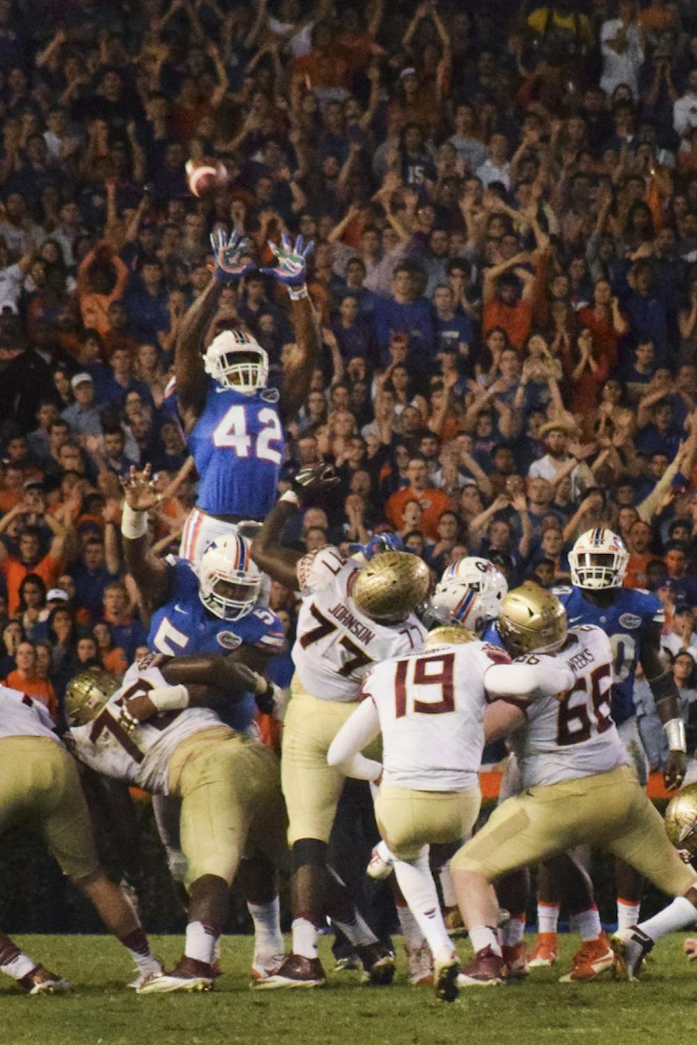 <p>UF safety Keanu Neal (42) jumps in an attempt to block FSU kicker Roberto Aguayo's field goal attempt during Florida's 27-2 loss to Florida State on Nov. 28, 2015, at Ben Hill Griffin Stadium.</p>