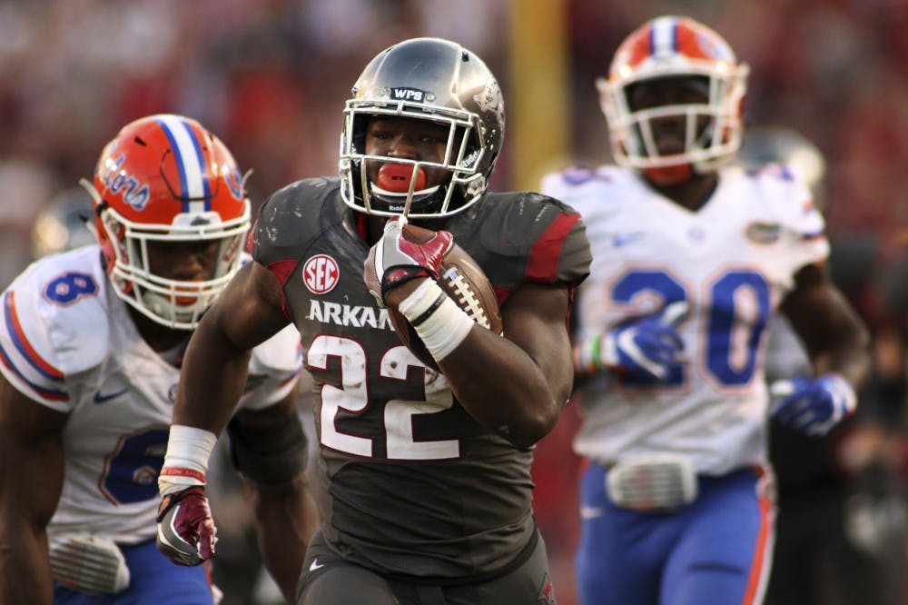 Arkansas' Rawleigh Williams III (22) outruns Florida's Nick Washington (8) and DeAndre Goolsby (30) during the second half of an NCAA college football game Saturday, Nov. 5, 2016 in Fayetteville, Ark. Arkansas beat Florida 31-10. (AP Photo/Samantha Baker)