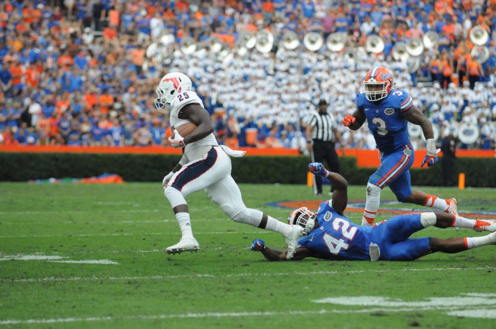 <p>UF's Antonio Morrison (3) pursues an FAU player during Florida's 20-14 overtime win against Florida Atlantic on Nov. 21, 2015, at Ben Hill Griffin Stadium.</p>