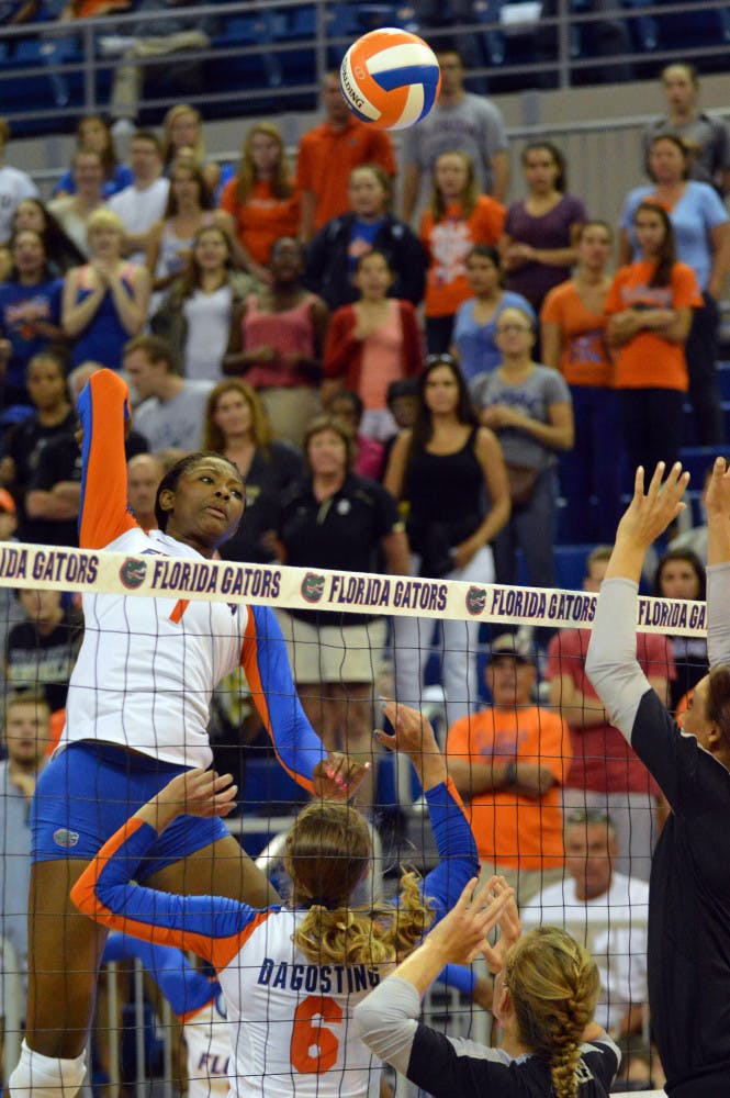 Freshman middle blocker Rhamat Alhassan swings for a kill during Florida's 3-0 win against Idaho on Aug. 29 in the O'Connell Center.