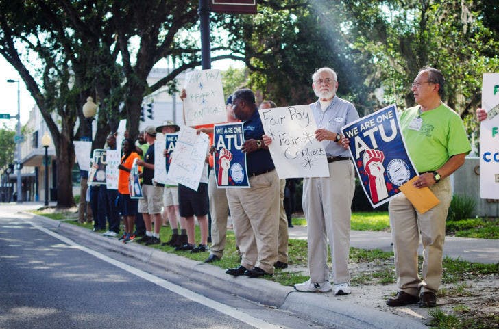 Power to the People - Antonio Cruz, 59, pictured right, joined the Amalgamated Transit Union in rallying support for the fair pay of RTS employees outside city hall on Thursday . Soon thereafter, the AT Union voiced their concerns at the city commission meeting.
