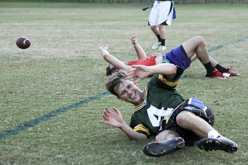 Michael Hauer, 21, falls while playing quarterback for the Chuggernauts in a flag football scrimmage against Campus Diplomats on Thursday.