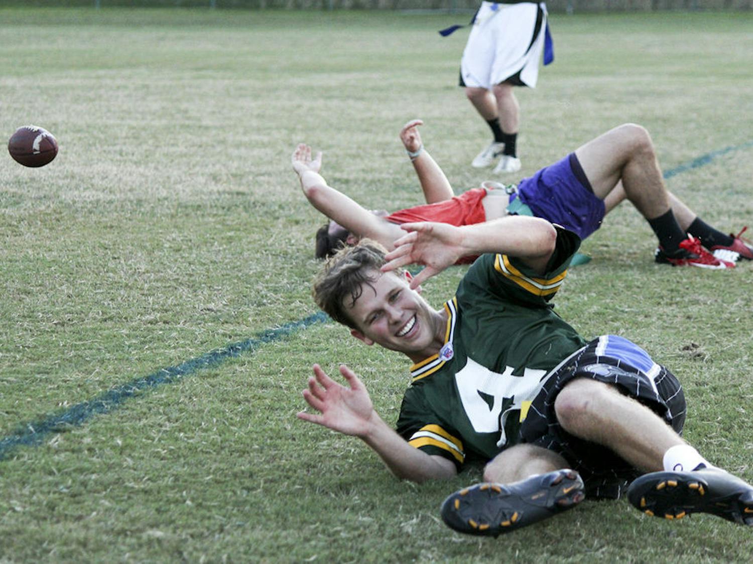 Michael Hauer, 21, falls while playing quarterback for the Chuggernauts in a flag football scrimmage against Campus Diplomats on Thursday.