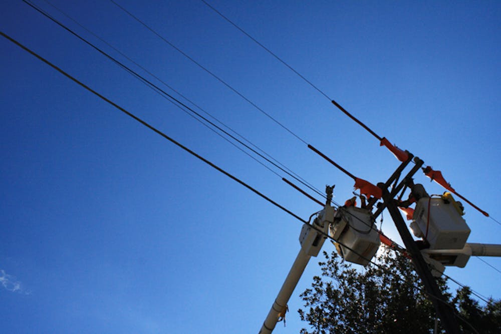<p>GRU workers Mark Roc and Ren Gallon work on power lines on Fifth Avenue on Thursday afternoon. "We are replacing everything but the pole," said GRU manager Dwayne Mercer.</p>