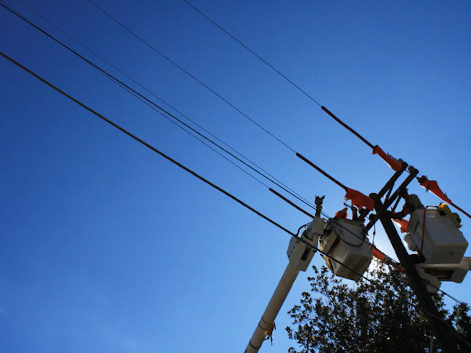 GRU workers Mark Roc and Ren Gallon work on power lines on Fifth Avenue on Thursday afternoon. "We are replacing everything but the pole," said GRU manager Dwayne Mercer.
