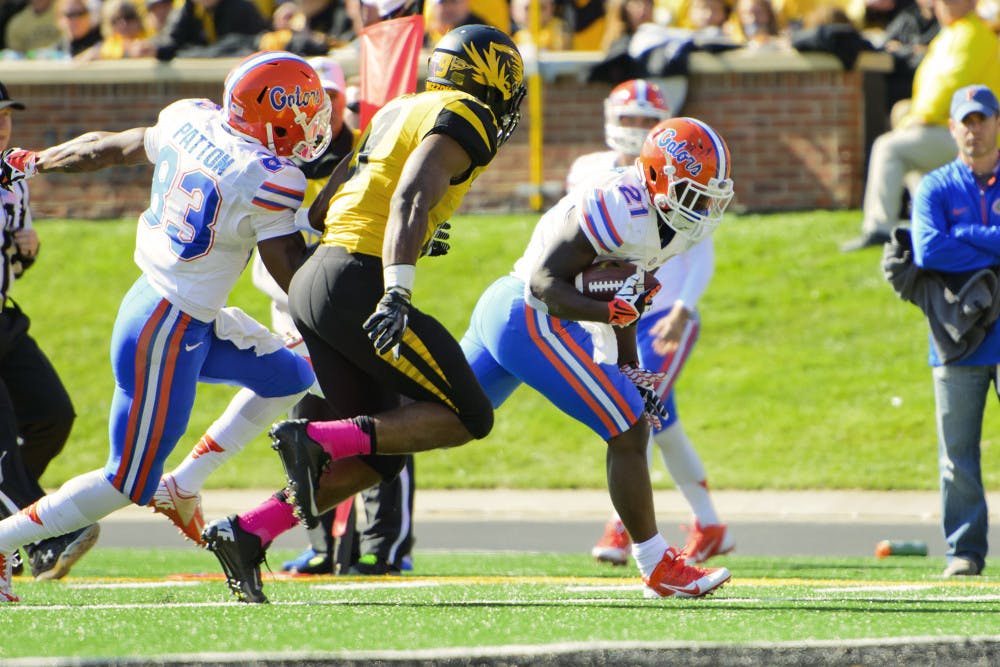 Freshman running back Kelvin Taylor (21) races to the end zone down the left sideline during the No. 22 Gators' 36-17 loss to the No. 14 Tigers on Saturday in Faurot Field in Columbia, Mo.