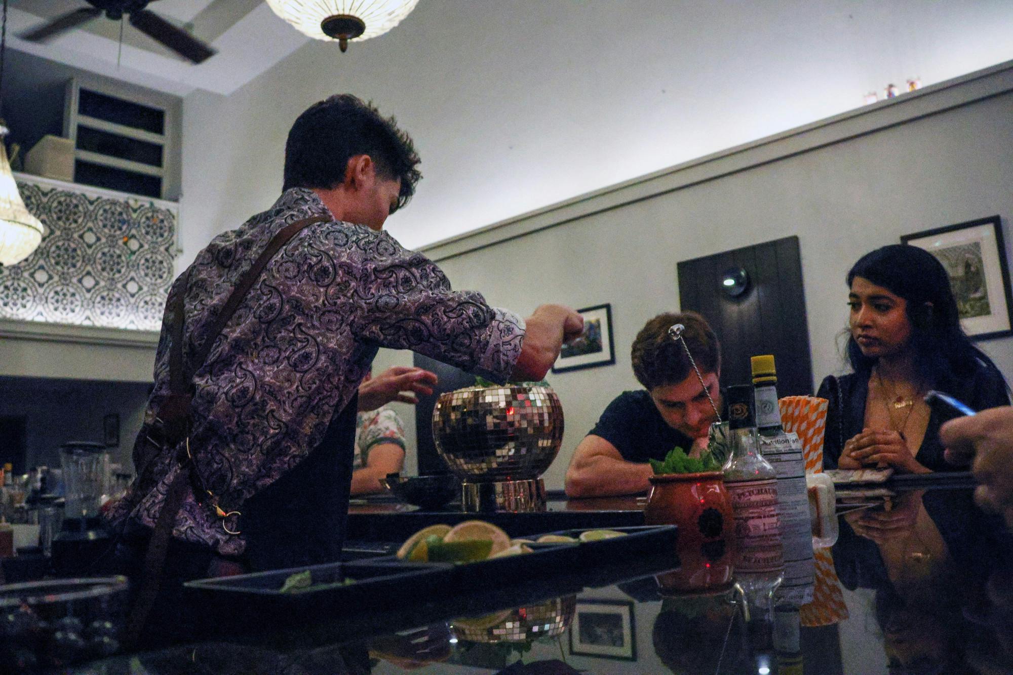 A bartender makes drinks for customers inside Madrinas during the bar’s “last dance” Friday, Nov 11, 2022.