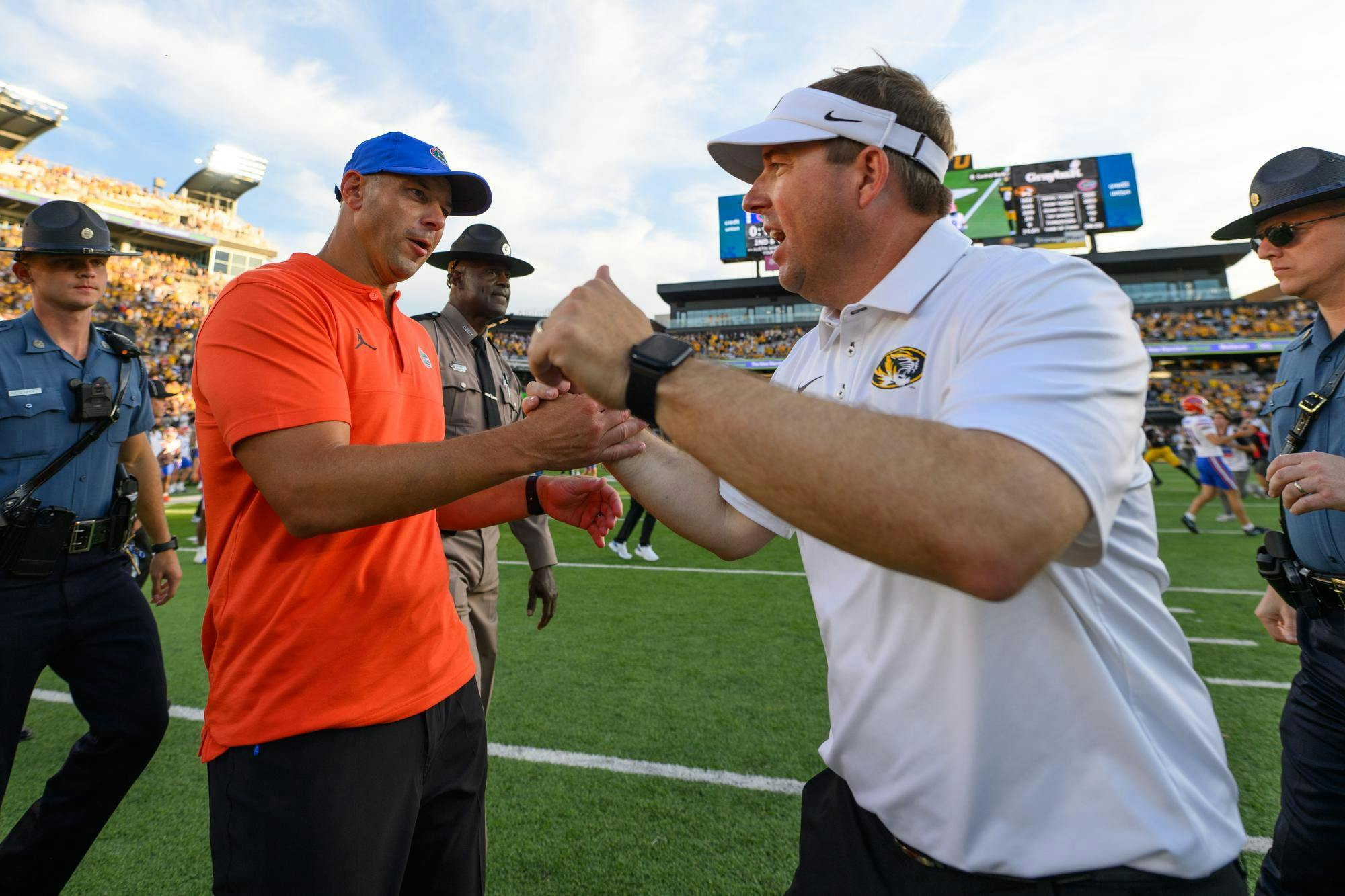 Florida head coach Jon Sumrall shakes hands with Missouri head coach Eli Drinkwitz after losing an NCAA college football game, Saturday, Oct. 3, 2026, in Columbia, Mo.