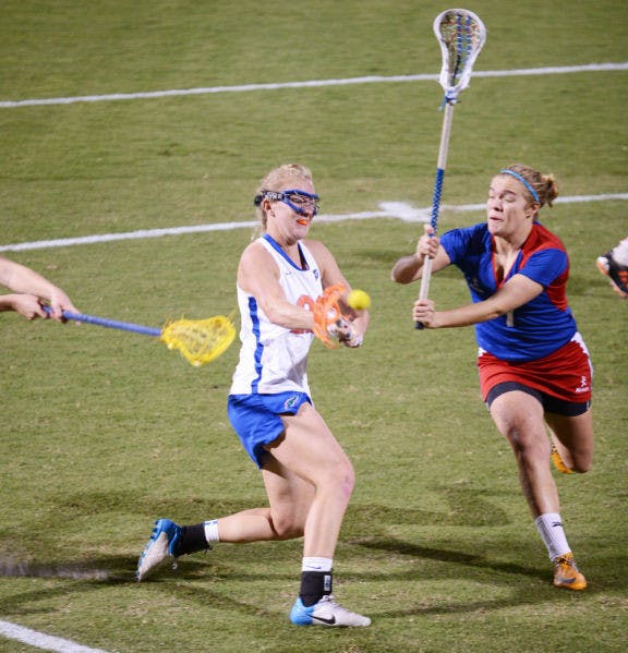 Senior Brittany Dashiell (left) attempts a shot during Florida’s 18-13 exhibition win against England on Jan. 24 at Dizney Stadium. Dashiell and the Gators defeated Stony Brook 16-9 on Wednesday.&nbsp;