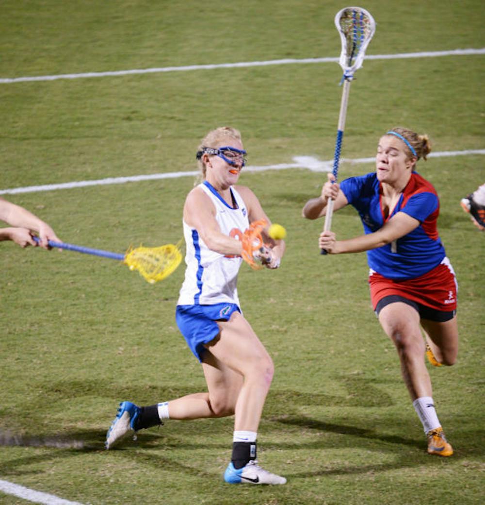 <p>Senior Brittany Dashiell (left) attempts a shot during Florida’s 18-13 exhibition win against England on Jan. 24 at Dizney Stadium. Dashiell and the Gators defeated Stony Brook 16-9 on Wednesday.&nbsp;</p>
