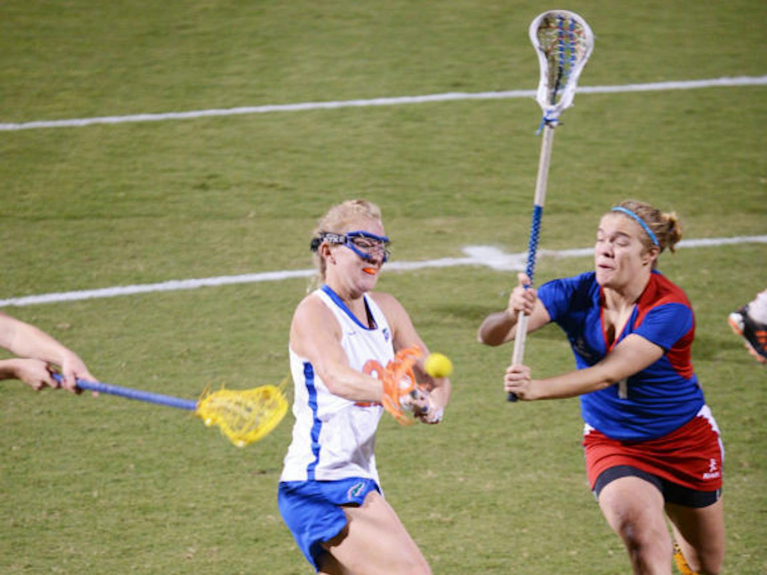 Senior Brittany Dashiell (left) attempts a shot during Florida’s 18-13 exhibition win against England on Jan. 24 at Dizney Stadium. Dashiell and the Gators defeated Stony Brook 16-9 on Wednesday. 