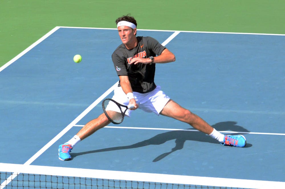 Gordon Watson hits an underhand volley during Florida men's tennis' 4-3 loss to Ole Miss on Jan. 31, 2015 at the Ring Tennis Complex.