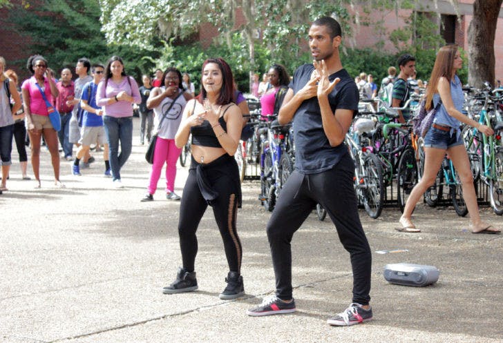 Amanda Hanono, a 20-year-old UF psychology senior, and Brandon Robinson, a 20-year-old UF marketing junior, dance to Beyonce’s “Single Ladies (Put A Ring on It)” on Turlington Plaza on Monday.