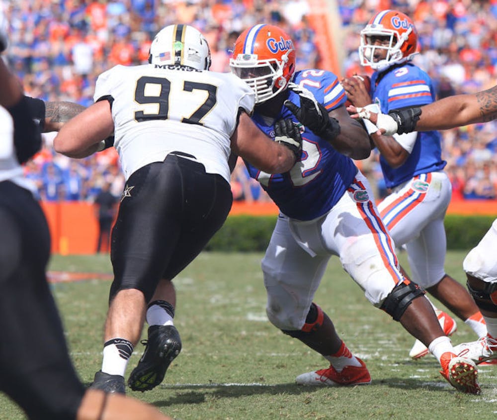 <p>Jon Harrison (72) attempts to block Vanderbilt defensive tackle Jared Morse (97) as Tyler Murphy (3) drops back during the Gators’ 34-17 loss to the Commodores.</p>