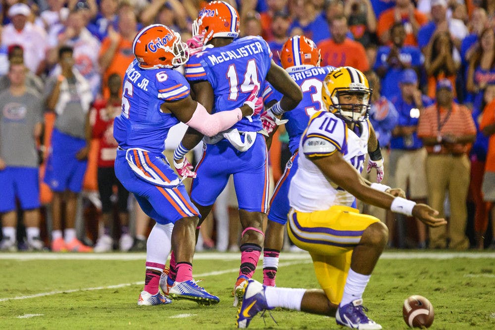 Alex McCalister celebrates with Dante Fowler Jr. after a sack during Florida's 30-27 loss to LSU on Saturday at Ben Hill Griffin Stadium.
