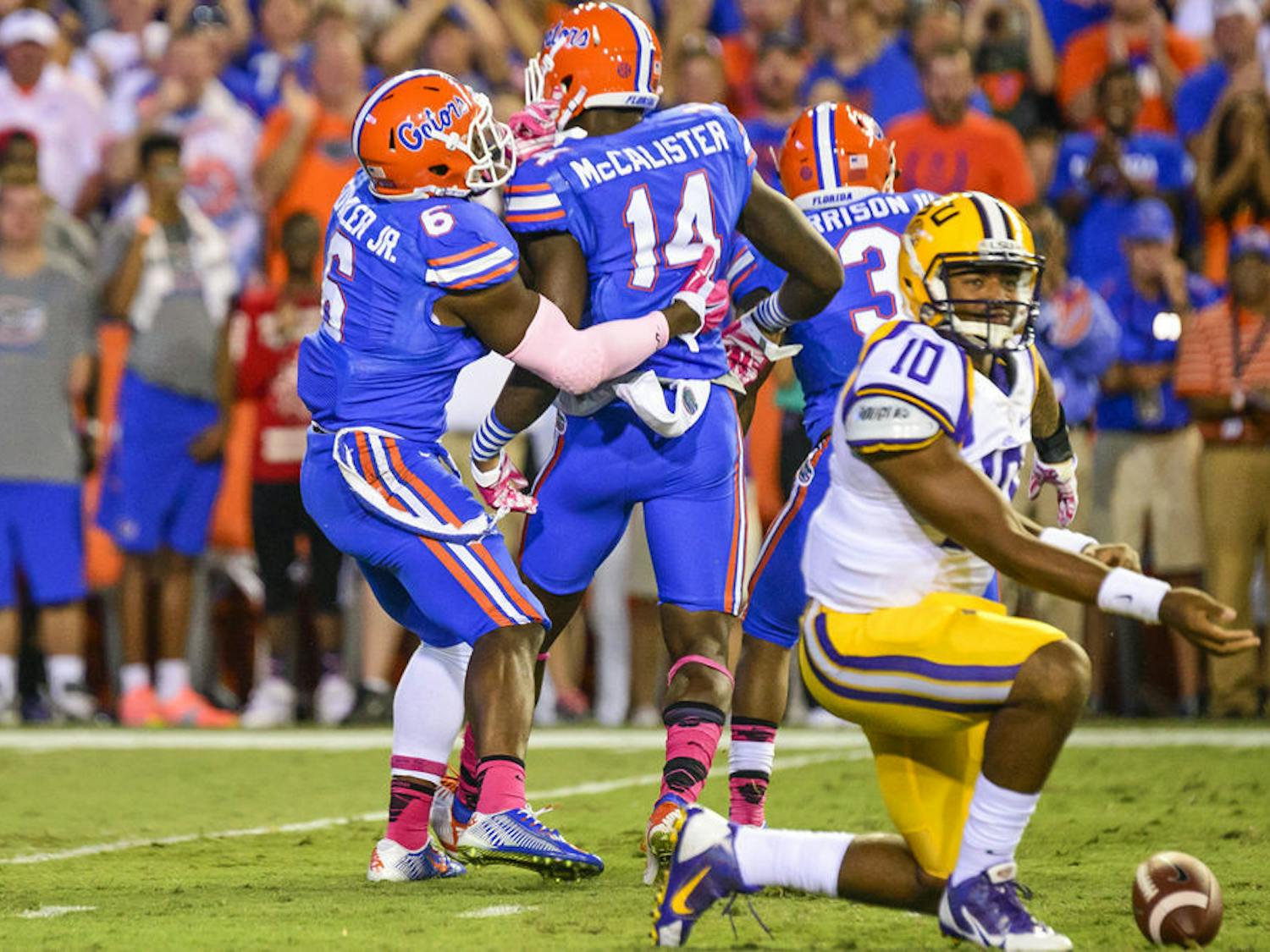 Alex McCalister celebrates with Dante Fowler Jr. after a sack during Florida's 30-27 loss to LSU on Saturday at Ben Hill Griffin Stadium.