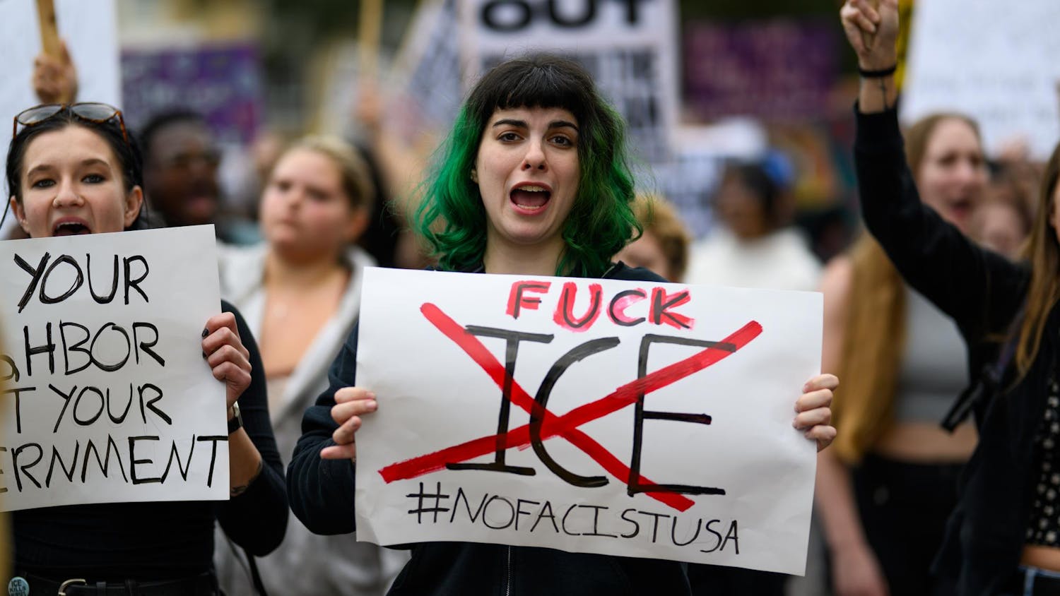 A demonstrator holds a sign during an ICE protest organized by YDSA, Friday, Jan. 30, 2026, along University Avenue in Gainesville, Fla.