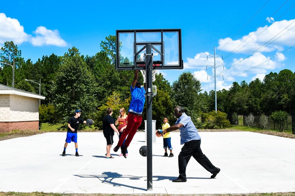 Local charter school receives new basketball court celebrates with law