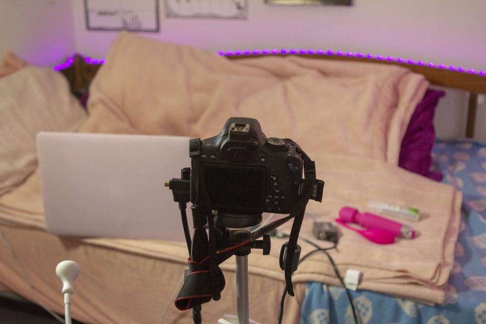 <p>A.G. sets up her workplace before starting her sessions on camera.</p>