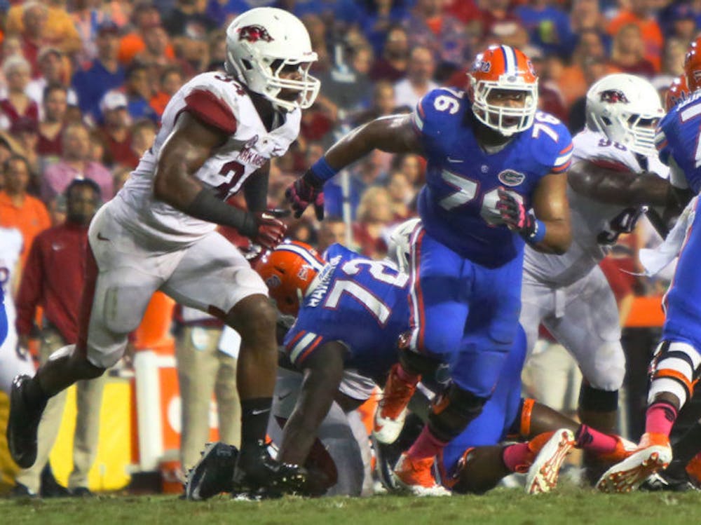<p align="justify">Max Garcia (76) runs at an opposing player during Florida’s 30-10 victory against Arkansas on Oct. 5, 2013, in Ben Hill Griffin Stadium. Garcia moved from guard to center during spring practice.</p>