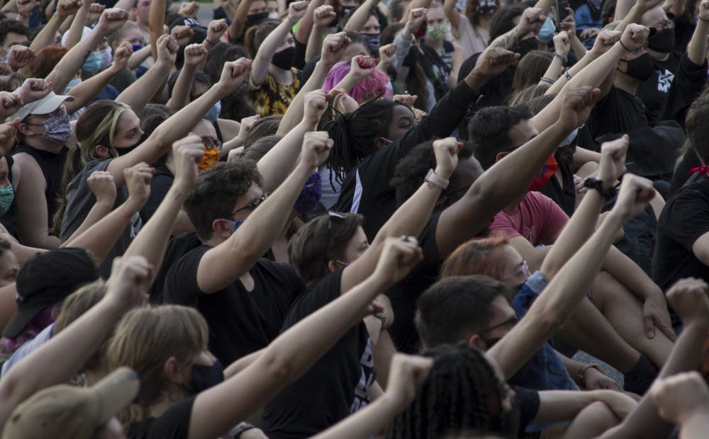 GoDDsville Dream Defenders use the stop at the Gainesville Police Department to announce a list of demands that the organization will present to local government officials. Hundreds of fists rise into the air as the crowd chants “No justice, no peace.”
&nbsp;