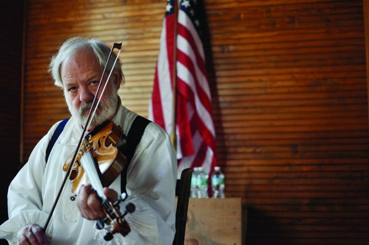 Jay Gimelli, a Longleaf Pine Youth Fiddle Contest judge, plays fiddle before the contest.