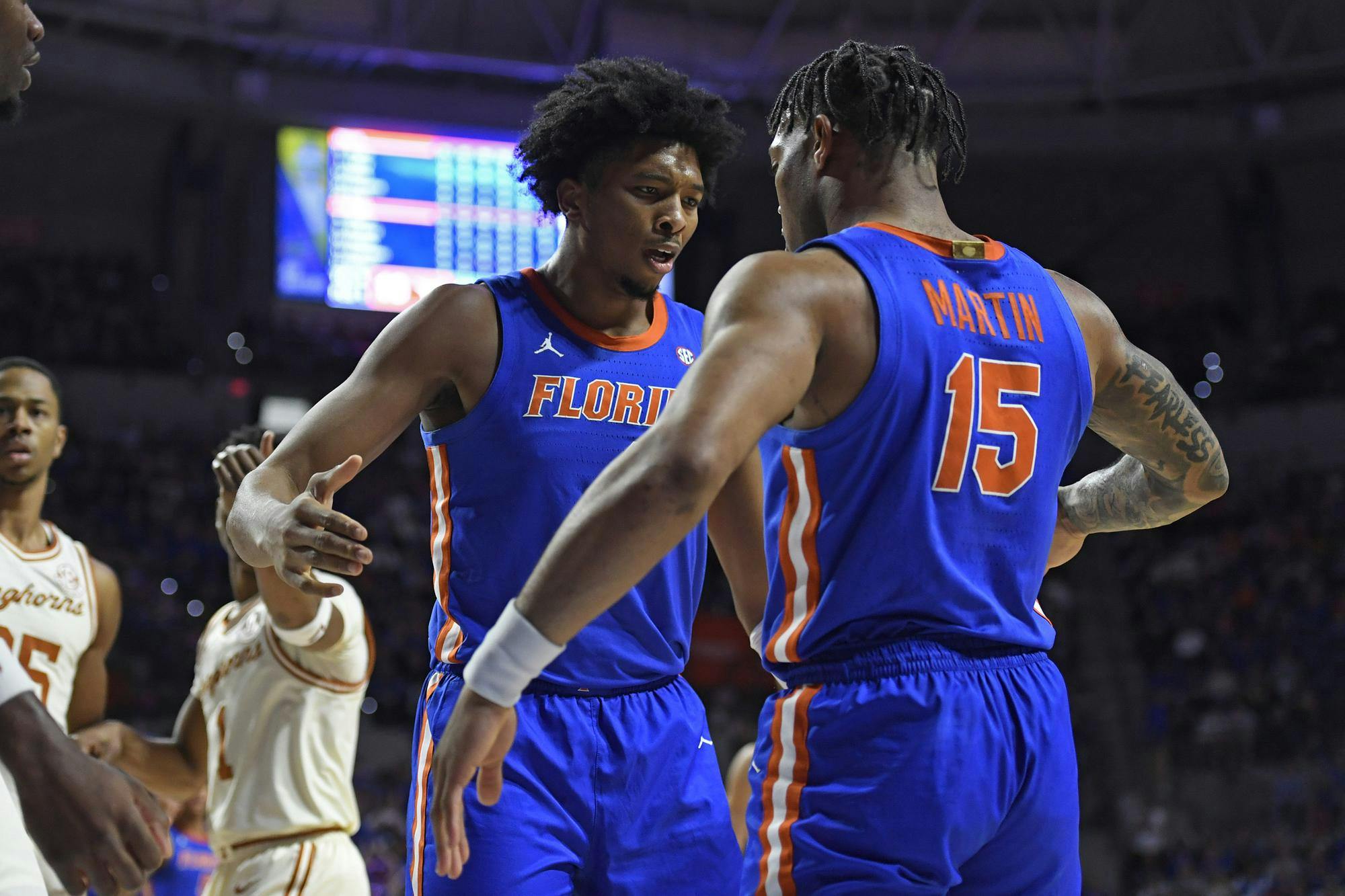 GAINESVILLE, FL - JANUARY 18: Florida forward Sam Alexis (4) celebrates with guard Alijah Martin (15) as the Florida Gators faced the Texas Longhorns on Saturday, January 18, 2025, at the O’Connell Center in Gainesville, Florida. (Photo by Matthew Lewis)