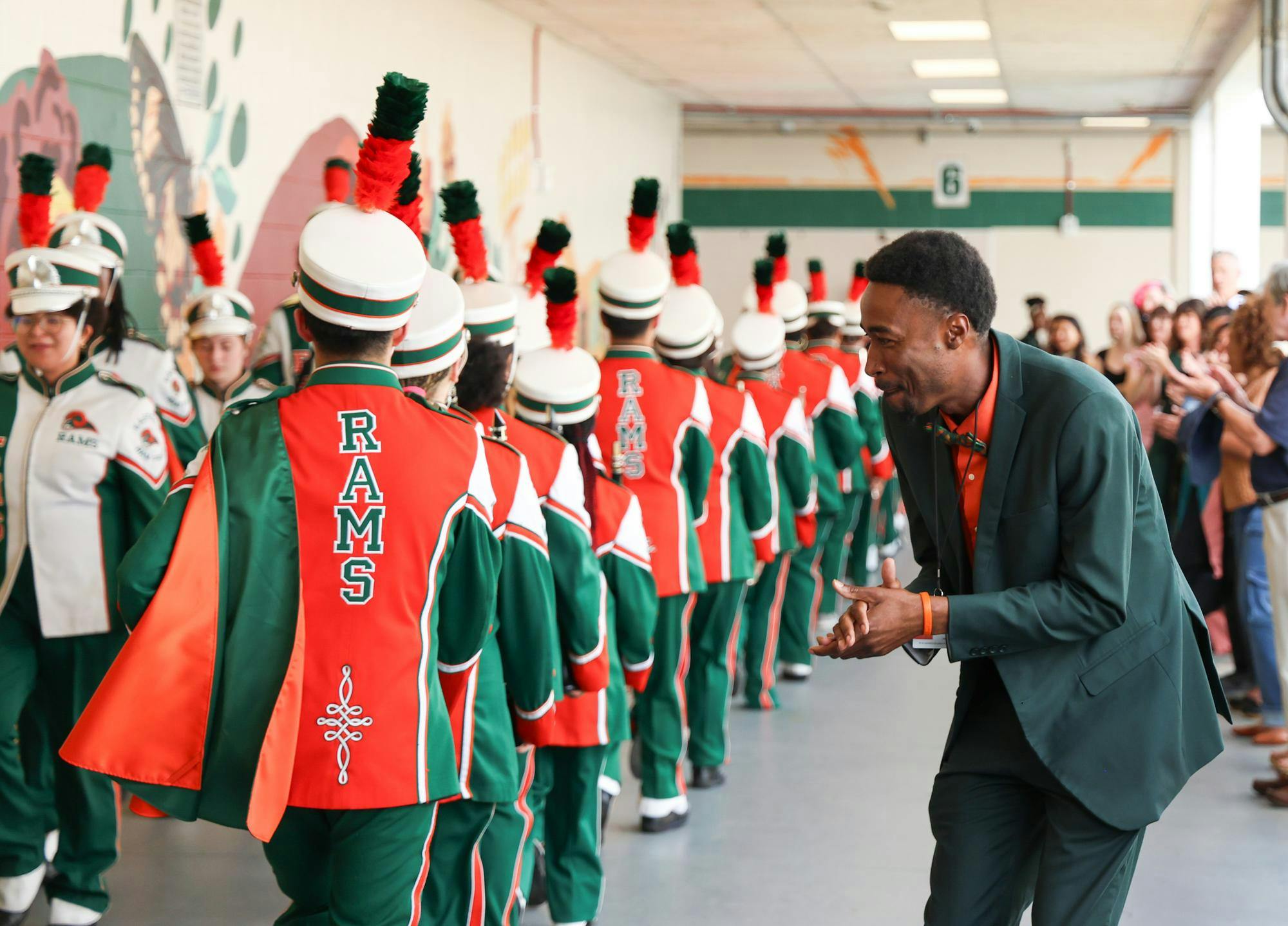Leroy Williams, the principal of Eastside High school, cheers on the band after their performance at the unveiling of the mindful messages mural, Tuesday, March 31, 2026, in Gainesville, Fla.
