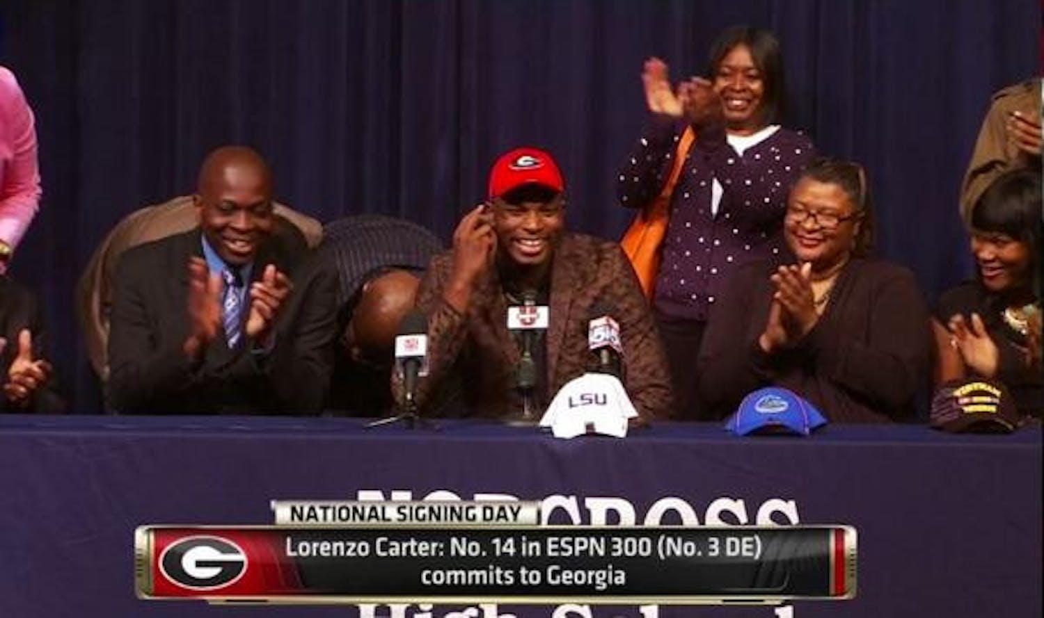Four-star defensive end Lorenzo Carter selects Georgia over Florida and LSU during a ceremony at his high school, Norcross (Ga.) High, on Wednesday afternoon.