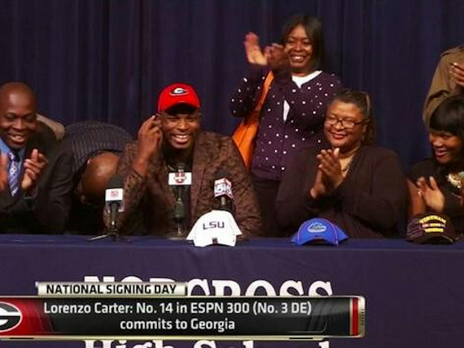 Four-star defensive end Lorenzo Carter selects Georgia over Florida and LSU during a ceremony at his high school, Norcross (Ga.) High, on Wednesday afternoon.