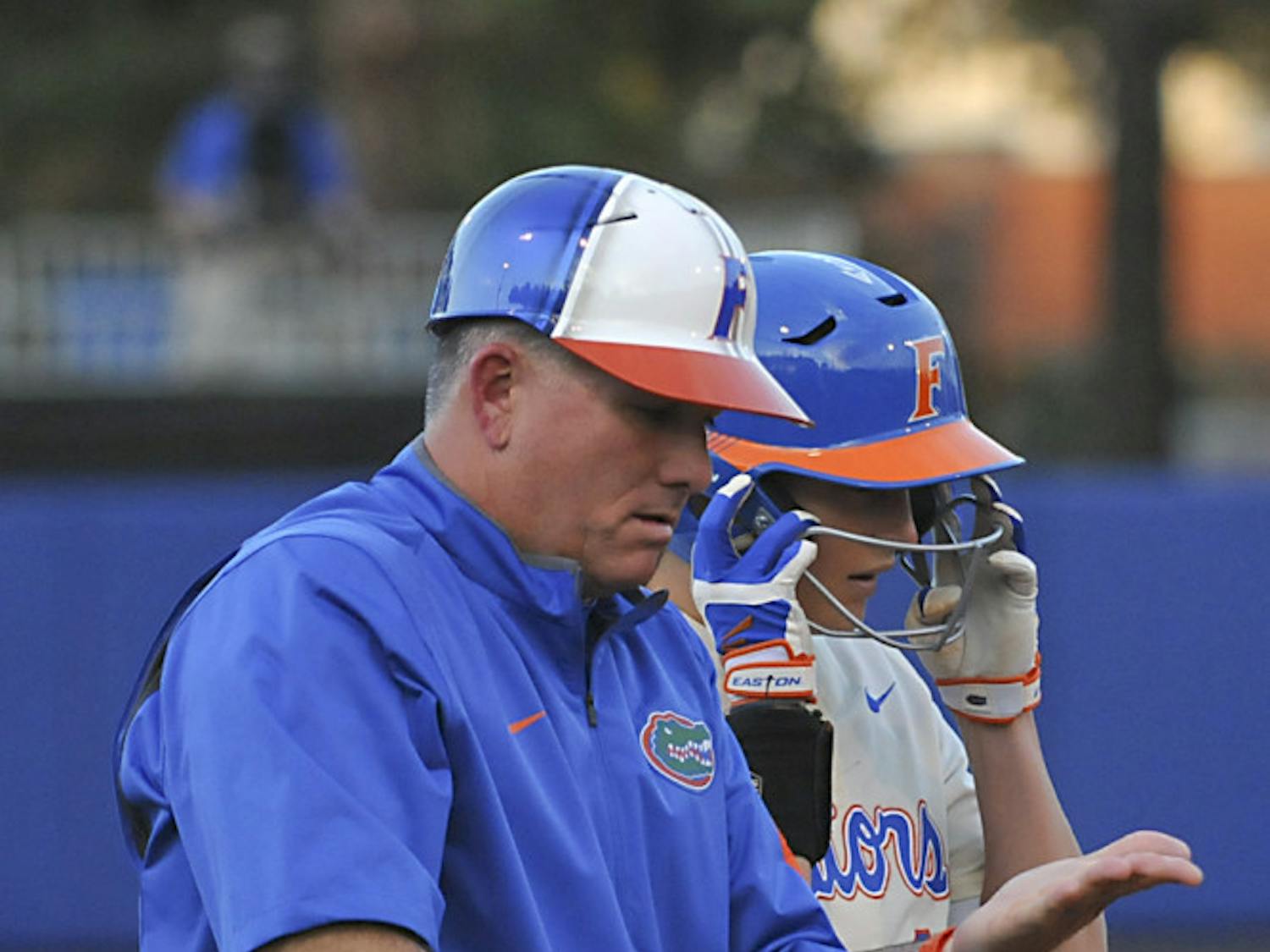 Tim Walton talks with Taylor Schwarz during Florida's doubleheader sweep of Jacksonville on Feb. 17, 2016, at Katie Seashole Pressly Stadium.