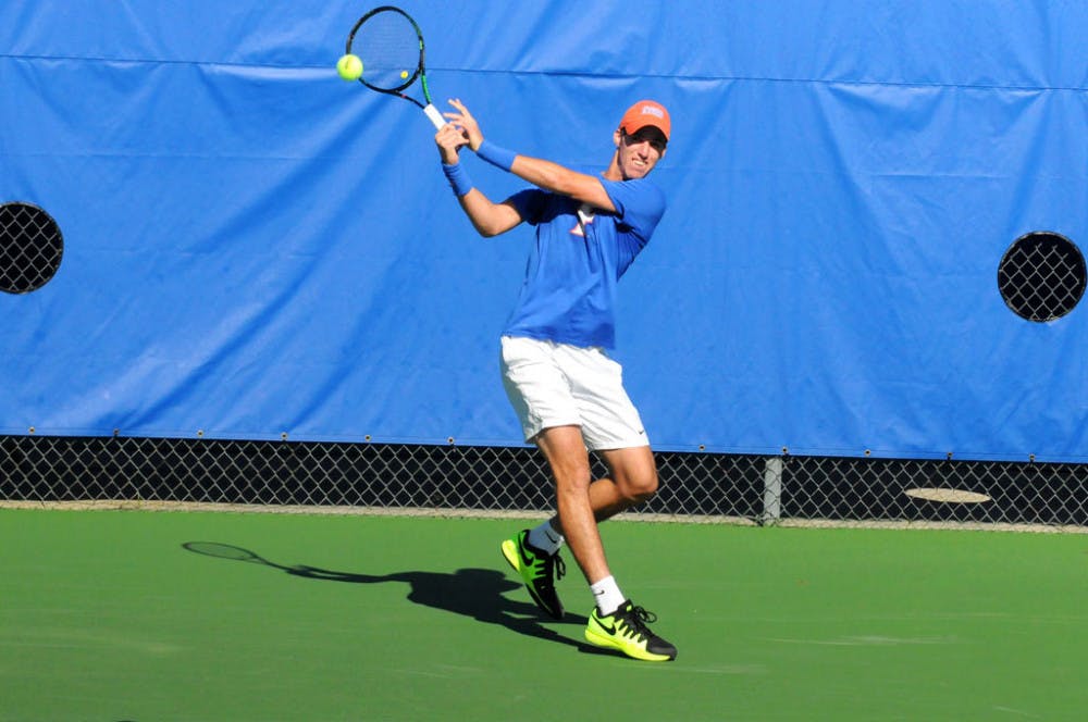 Alfredo Perez returns a ball during Florida's 6-1 win over Troy on Jan. 17, 2016, at the Ring Tennis Complex.