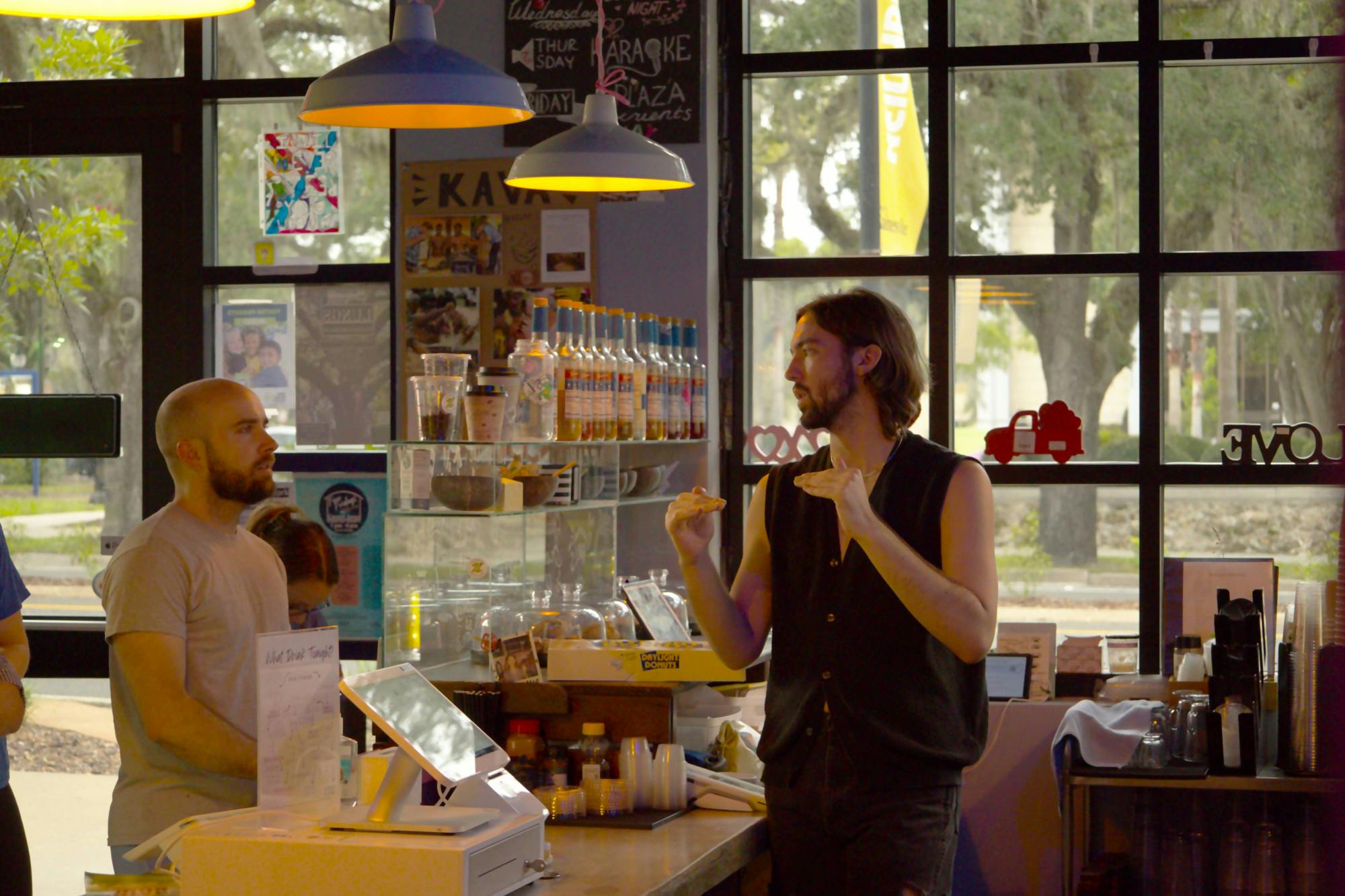 Mccade Moonshower, 23, explains the effects of kratom to a customer at Kava Gator on Wednesday, July 12, 2023.﻿