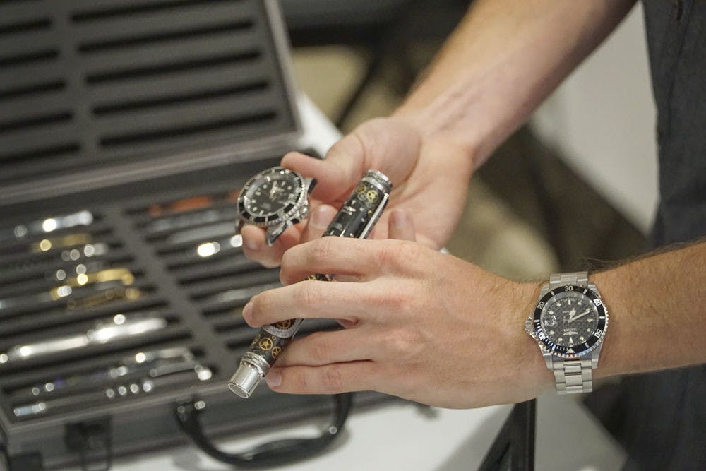 Marshell Petrik, a 21-year-old UF mechanical engineering senior, shows off his $500 handcrafted pen at the Harn Museum's Art in Engineering event Oct. 8, 2015. The pen, made from real watch parts, took Petrik 40 hours to craft. He said he has been making pens from a variety of materials for six years.