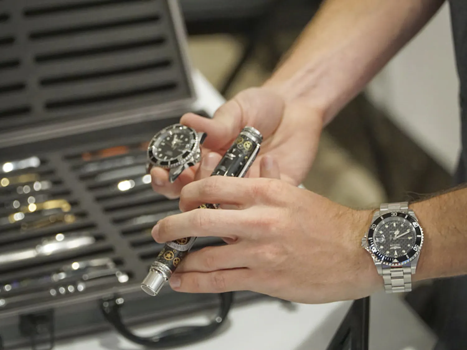 Marshell Petrik, a 21-year-old UF mechanical engineering senior, shows off his $500 handcrafted pen at the Harn Museum's Art in Engineering event Oct. 8, 2015. The pen, made from real watch parts, took Petrik 40 hours to craft. He said he has been making pens from a variety of materials for six years.