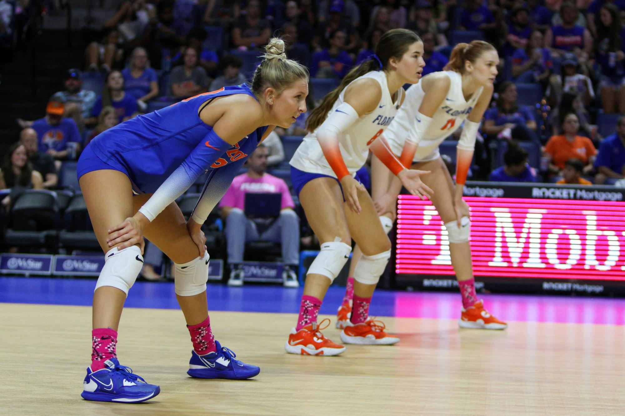 Libero Elli McKissock (left), defensive specialist Trinity Adams (center) and outside hitter Marina Markova prepare for a point during Florida's match with the LSU Tigers Saturday, Oct. 8, 2022. 