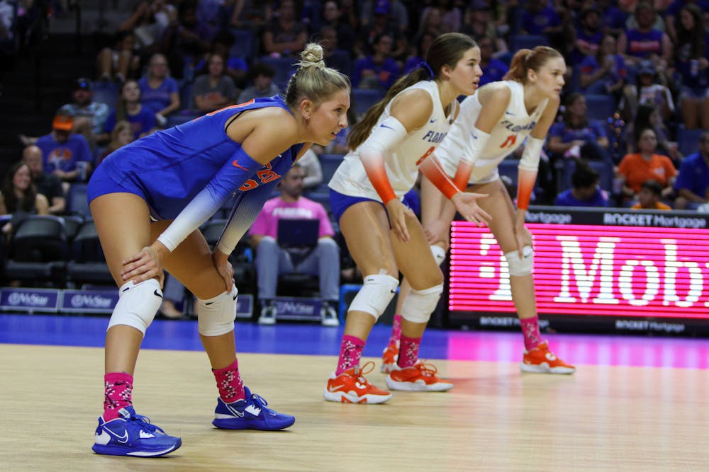 Libero Elli McKissock (left), defensive specialist Trinity Adams (center) and outside hitter Marina Markova prepare for a point during Florida's match with the LSU Tigers Saturday, Oct. 8, 2022. 