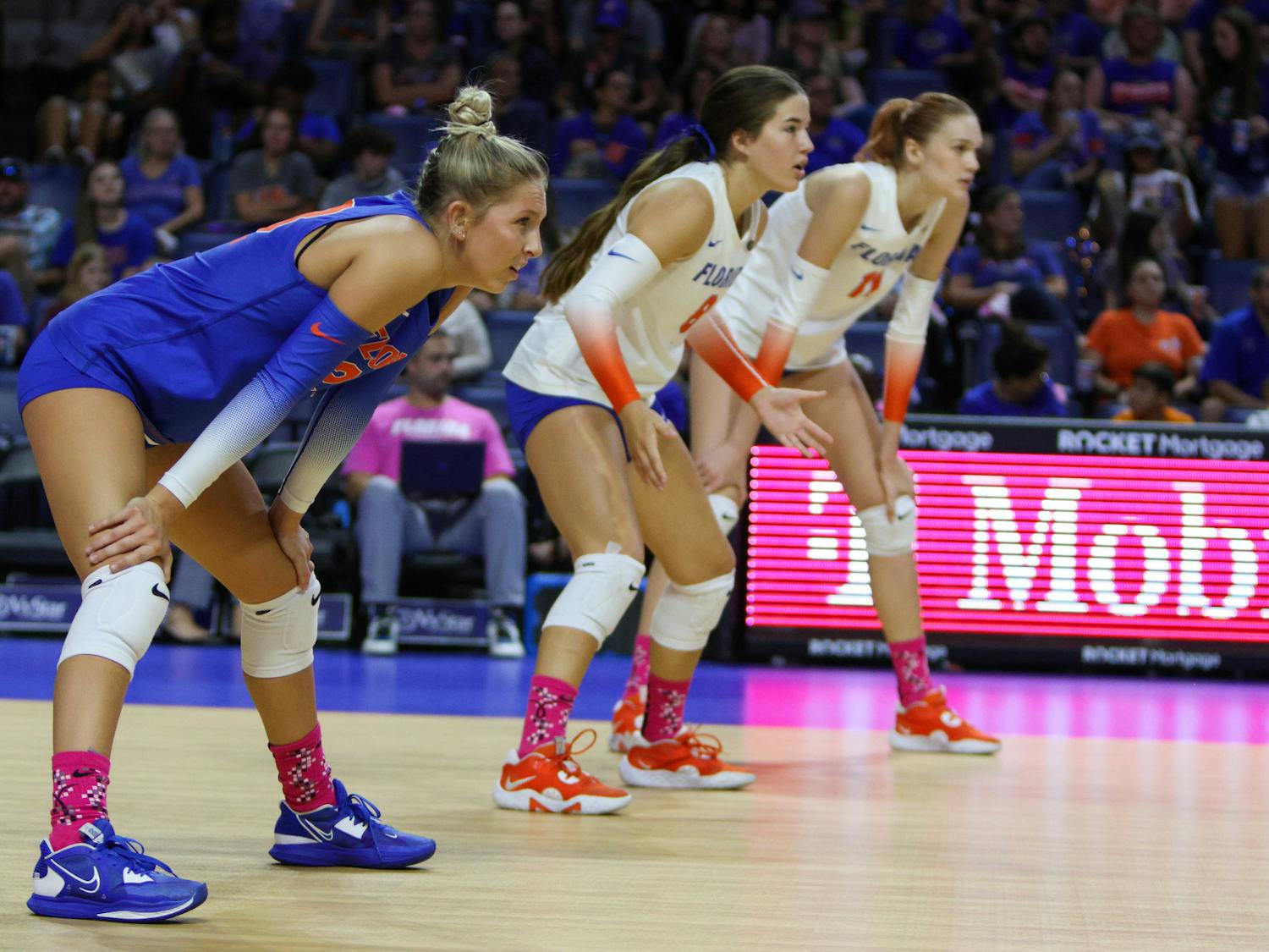 Libero Elli McKissock (left), defensive specialist Trinity Adams (center) and outside hitter Marina Markova prepare for a point during Florida's match with the LSU Tigers Saturday, Oct. 8, 2022.