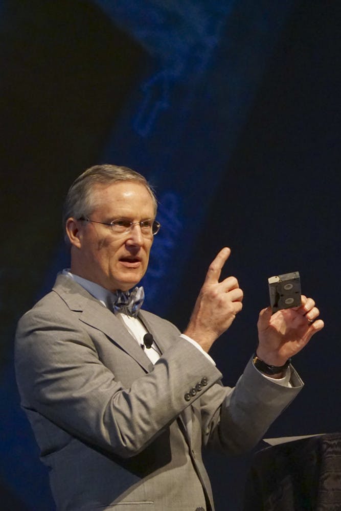 Chuck Clemons, Santa Fe’s Vice President for Advancement, shows off a water-damaged compact VHS tape from a 25-year-old time capsule during Santa Fe College's Convocation on Monday. Baseball cards, photos and other memorabilia were recovered from the container as well.