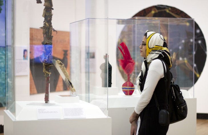 Faezeh Behzadnejad, 28, of New Jersey, browses “Kongo Across the Waters” Thursday at the Samuel P. Harn Museum of Art. The exhibit features archaeological discoveries and contemporary art.