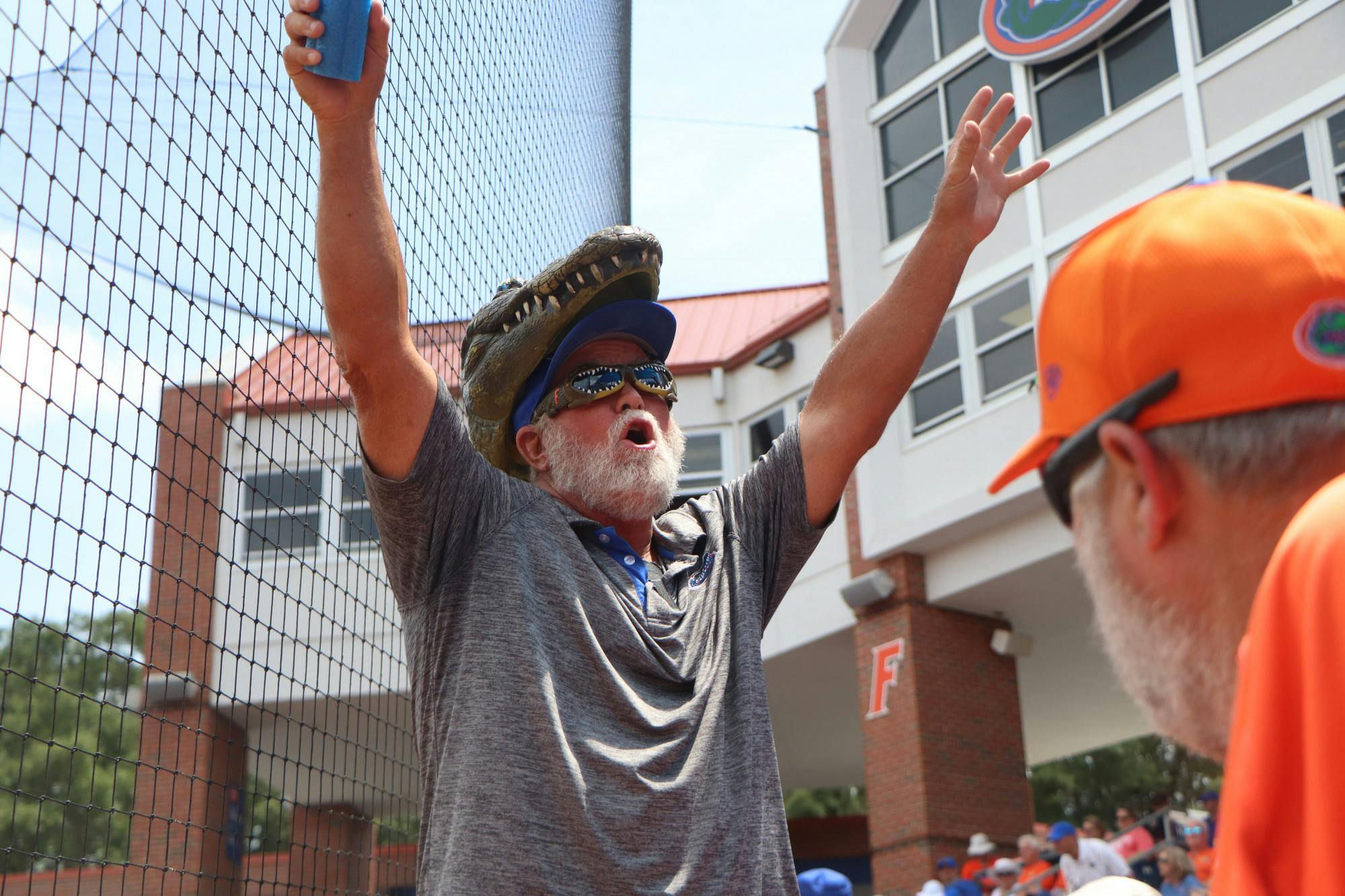 A Gator fan gets the crowd at Katie Pressly Seashole Stadium pumped up Friday. Florida&#x27;s 1-0 win was the first game with full capacity since March of 2020.