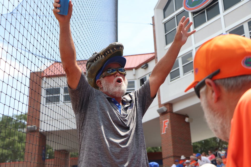 <p>A Gator fan gets the crowd at Katie Pressly Seashole Stadium pumped up Friday. Florida&#x27;s 1-0 win was the first game with full capacity since March of 2020.</p>