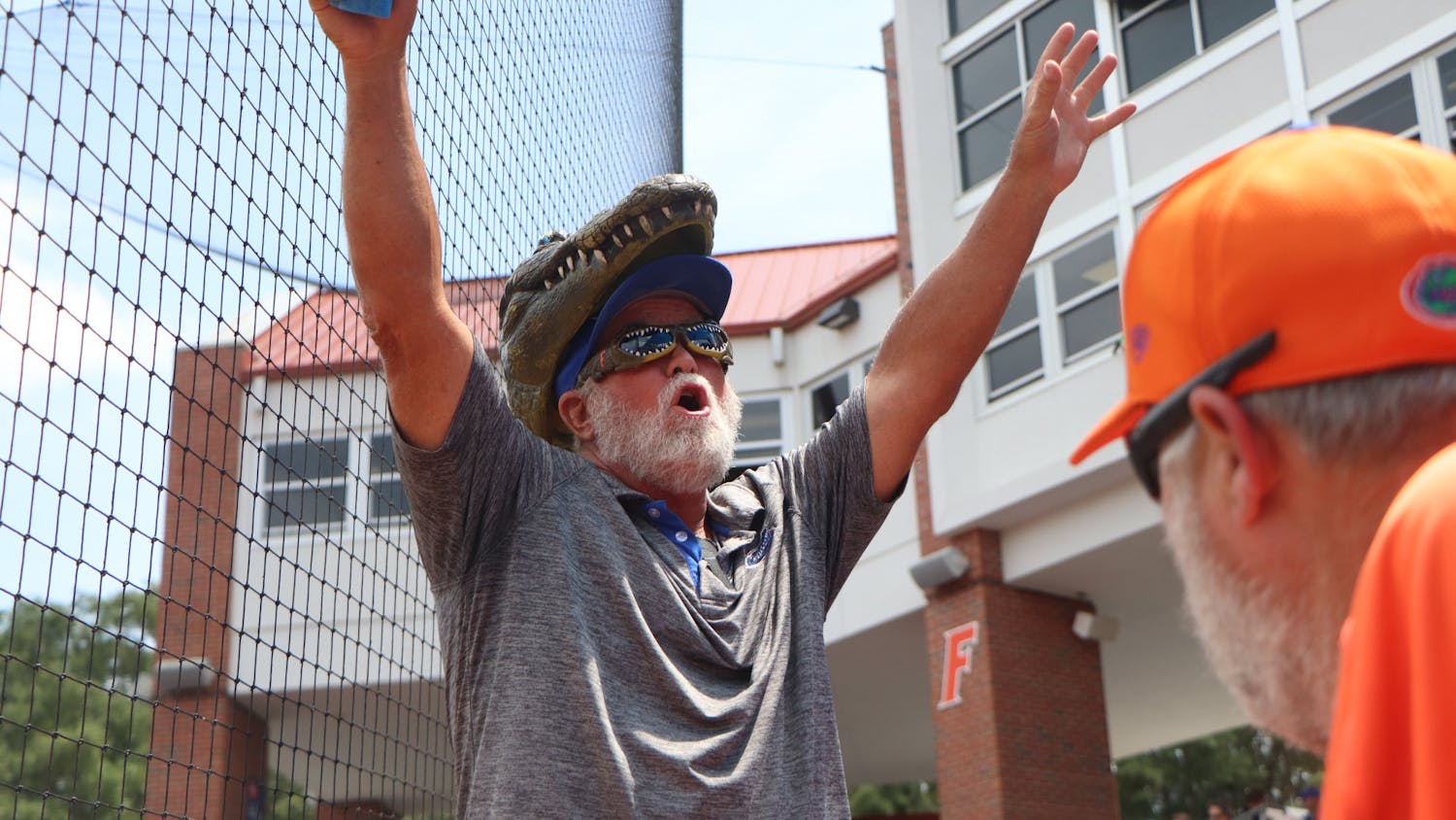 A Gator fan gets the crowd at Katie Pressly Seashole Stadium pumped up Friday. Florida&#x27;s 1-0 win was the first game with full capacity since March of 2020.