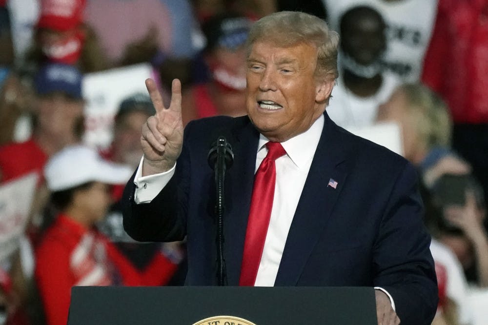 <p>President Donald Trump speaks at a campaign rally at the Orlando Sanford International Airport Monday, Oct. 12, 2020, in Sanford, Fla.</p>