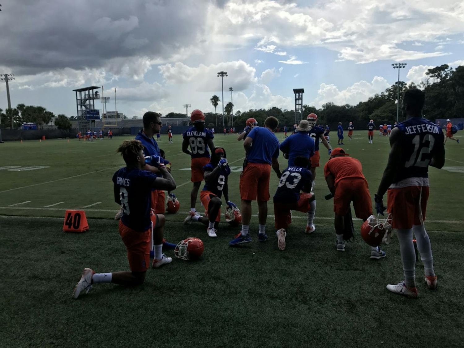 A unit of Florida wide receivers, including transfers Van Jefferson (12) and Trevon Grimes (8), rests during Day 1 of fall camp after catching passes from the quarterbacks. 