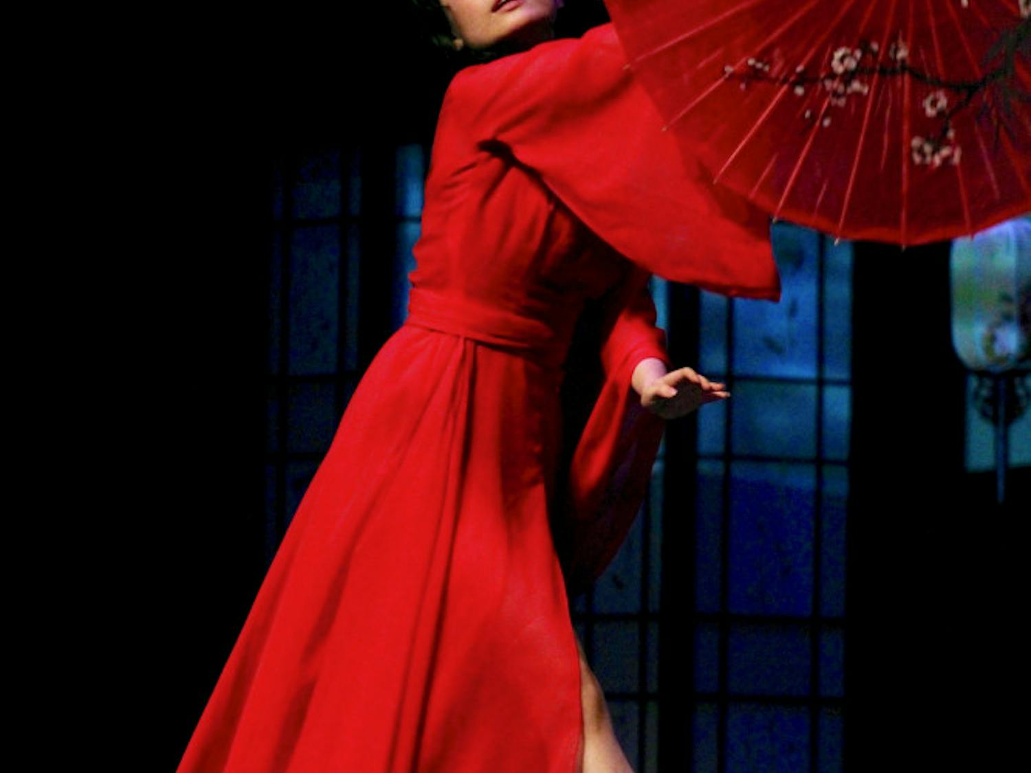 A dancer within the UF Chinese Student Association Dance Club performs in a piece titled "Zhi Zi Yugui + Cry Cry" while adorning traditional Chinese garments in honor of the new year inside the Phillips Center for Performing Arts on Sunday night.