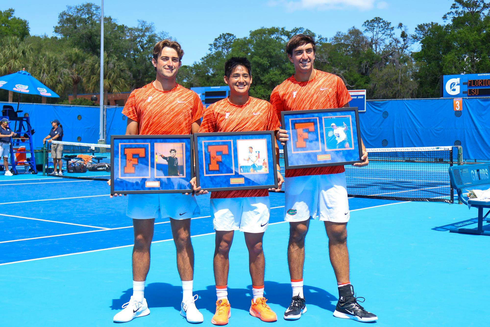 Pablo Perez, Tanapatt Nirundorn, and Lorenzo Clavier accept plaques honoring their time on the Florida Men's Tennis team at their senior night game against Louisiana State, Saturday, April 4, 2026.